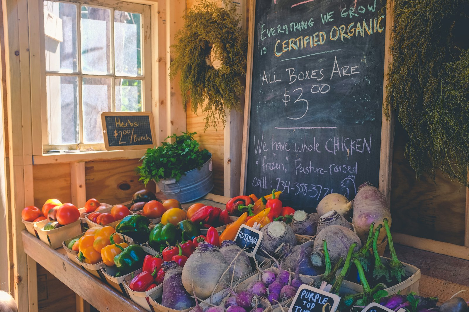 A warm timber store interior with baskets of vegetables under a hand-chalked price board (placeholder photo)